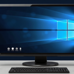 Desktop monitor with Windows logo, gear, shield and fingerprint icons on screen