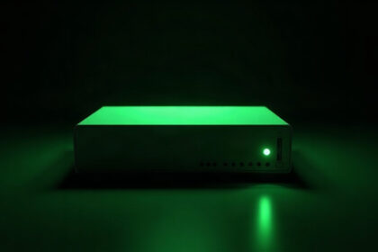 A single blank Zyxel-style network switch glowing green in the dark