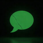 An empty green speech bubble with a crack running through it