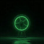 A single green industrial valve wheel beside a suspended droplet